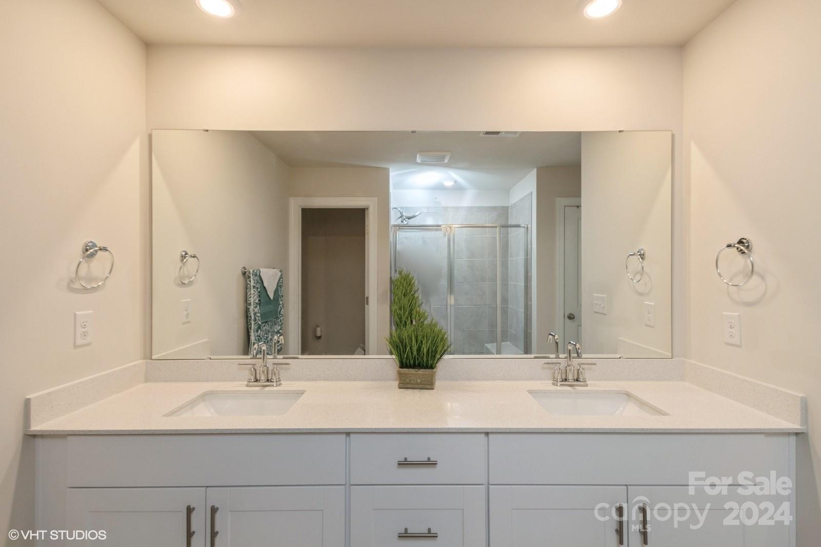 11955 Old Statesville Road Huntersville, NC 28078 - Photo 22 of 39 a bathroom with double vanity sinks and a mirror