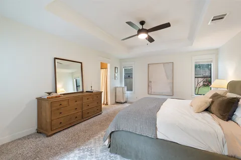 a bedroom with a bed and ceiling fan