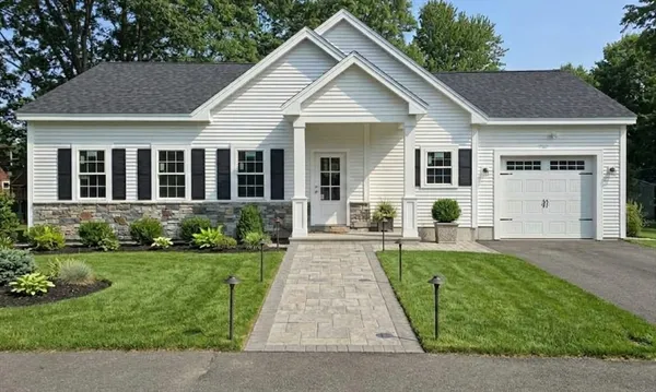 a front view of a house with a yard and porch
