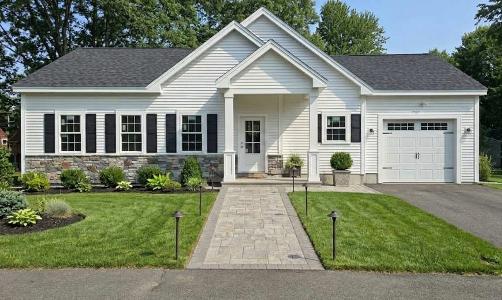 a front view of a house with a yard and porch