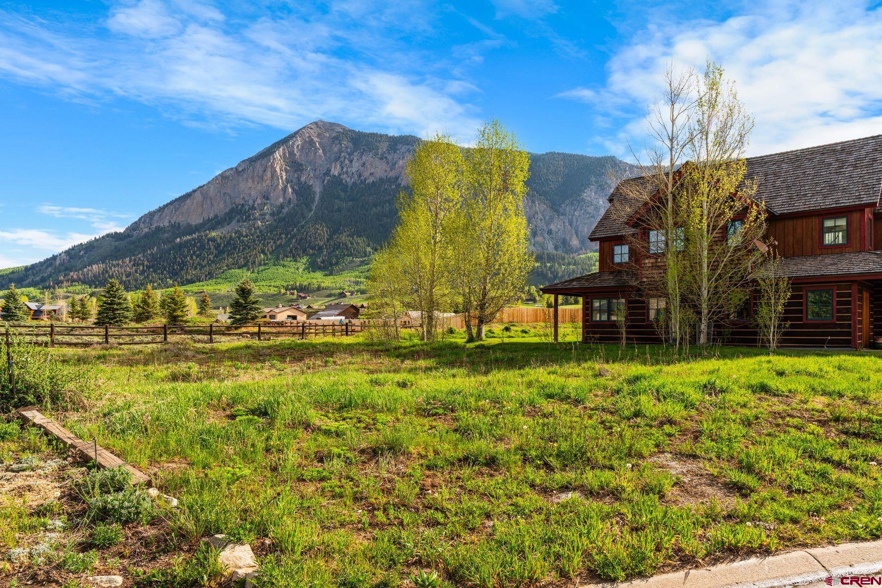 140 Alpine Court Crested Butte, CO 81224 - Photo 5 of 19 a view of a garden with a building in the background