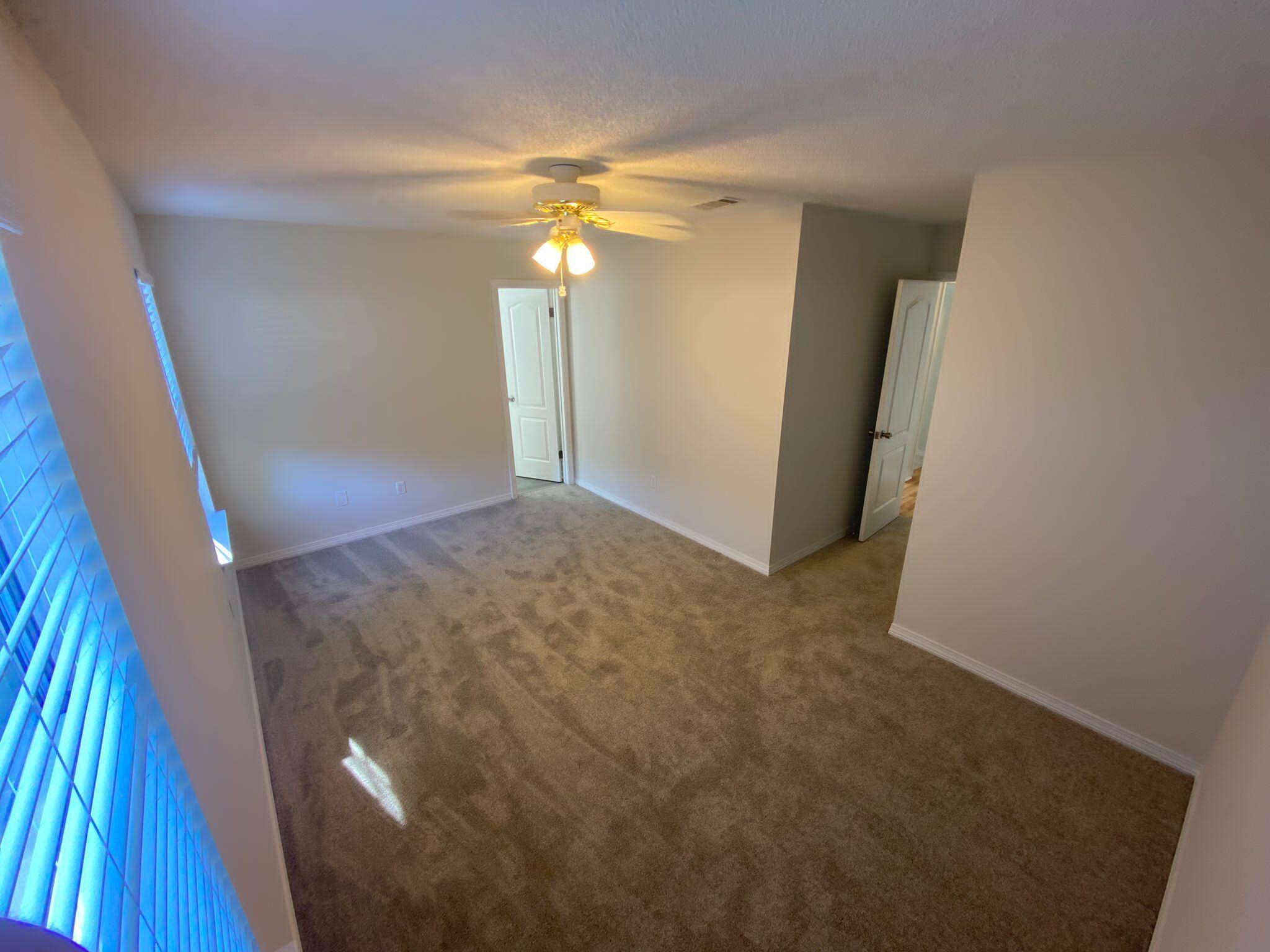 407 Apple Drive Crestview, FL 32536 - Photo 14 of 28 a view of a big room with closet and wooden floor