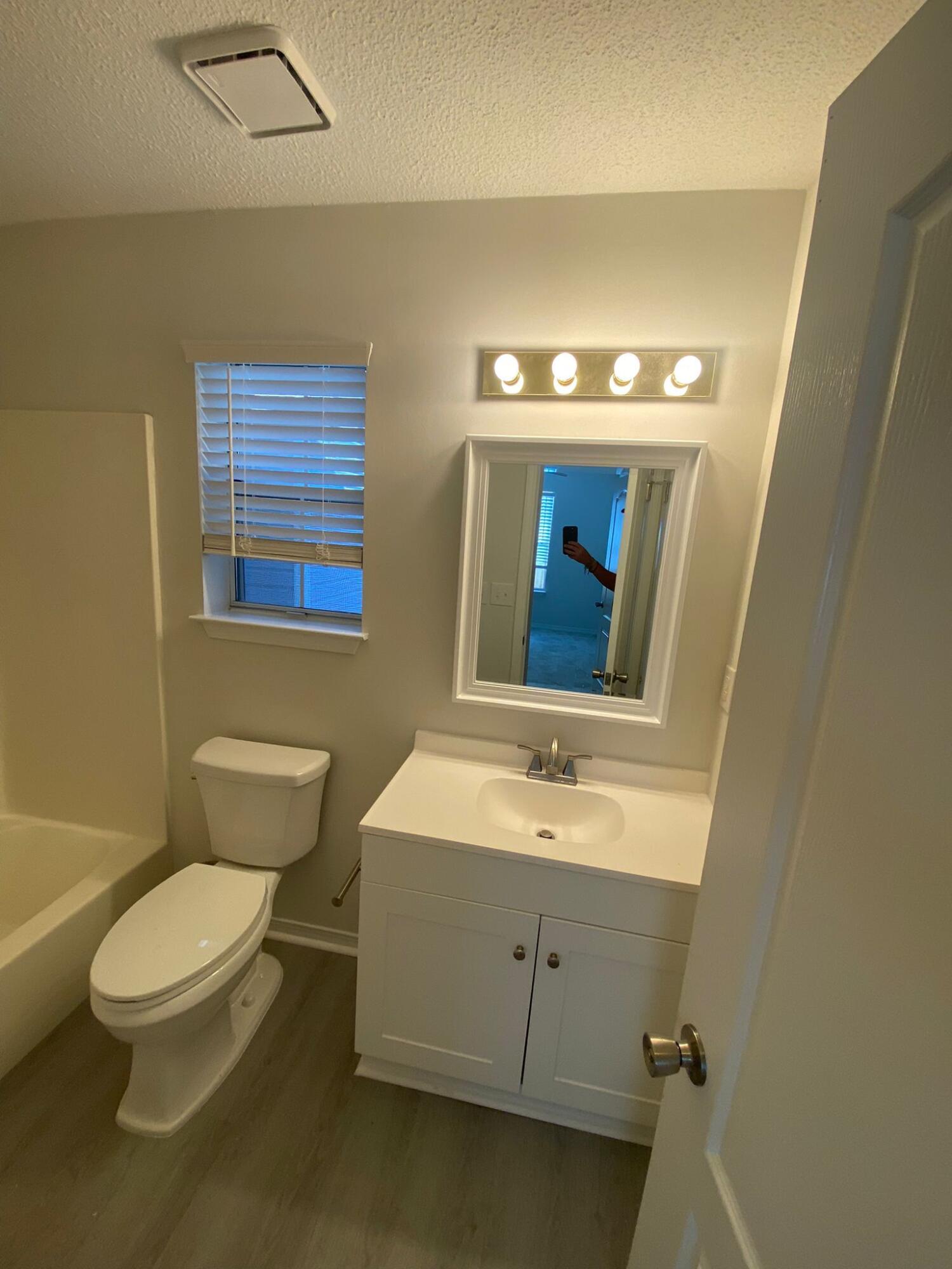 407 Apple Drive Crestview, FL 32536 - Photo 20 of 28 a bathroom with a toilet sink and mirror