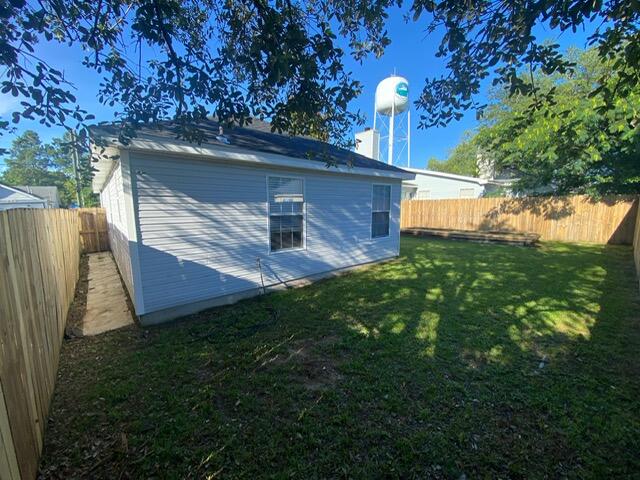 407 Apple Drive Crestview, FL 32536 - Photo 28 of 28 a view of backyard with deck and outdoor seating