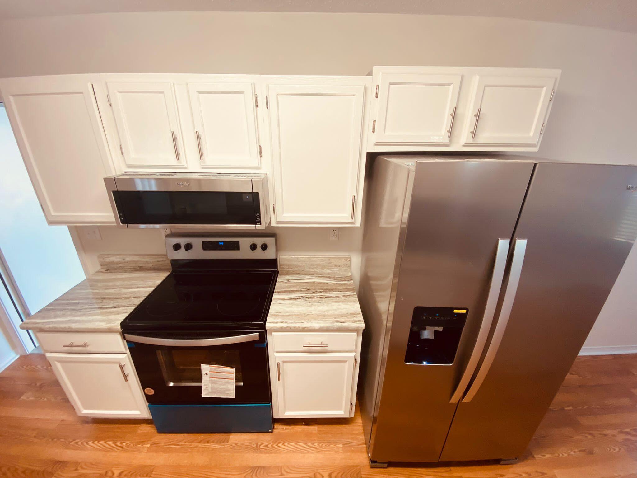 407 Apple Drive Crestview, FL 32536 - Photo 7 of 28 a kitchen with appliances and a counter