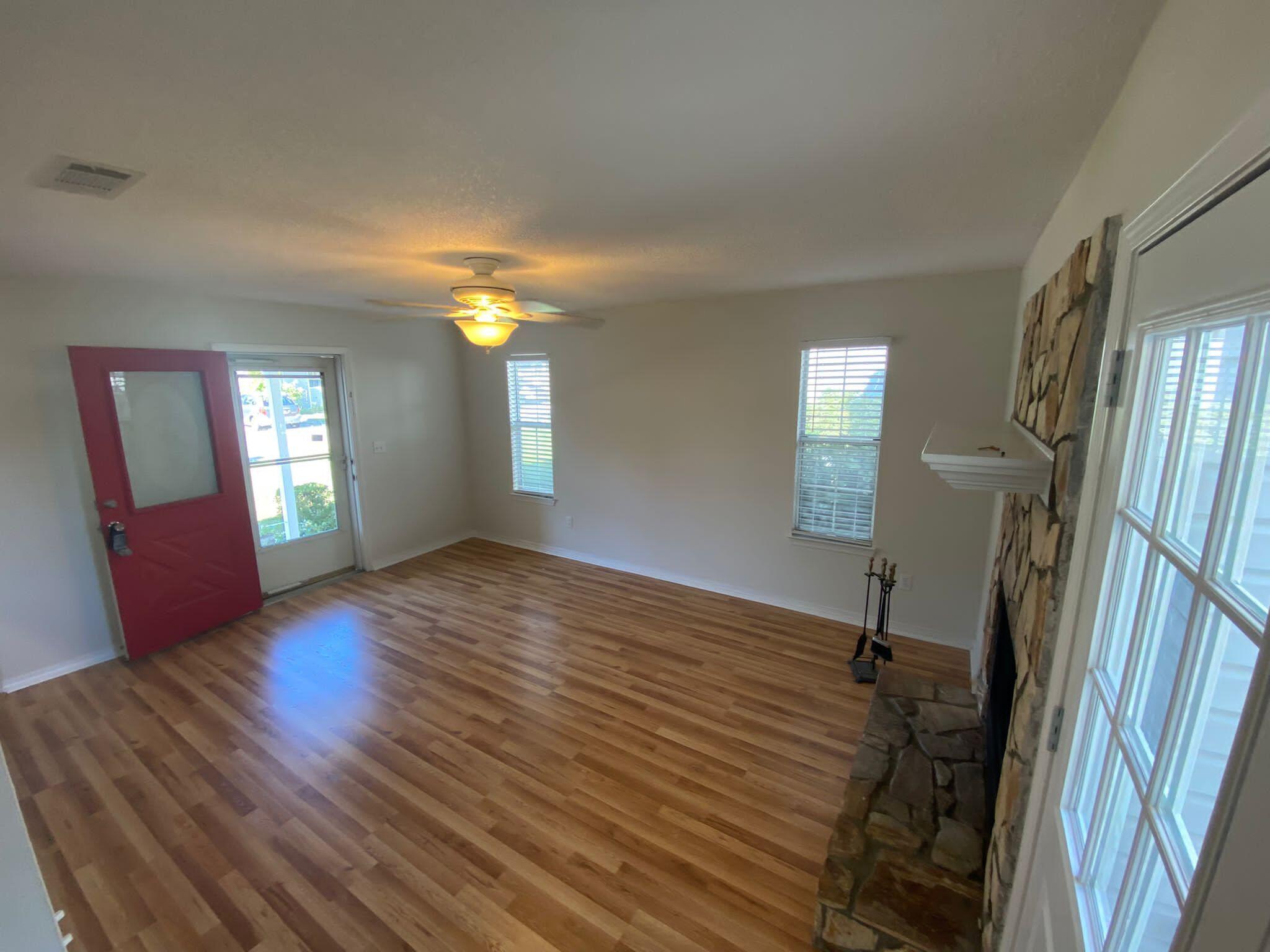 407 Apple Drive Crestview, FL 32536 - Photo 8 of 28 a view of an empty room with wooden floor and a window