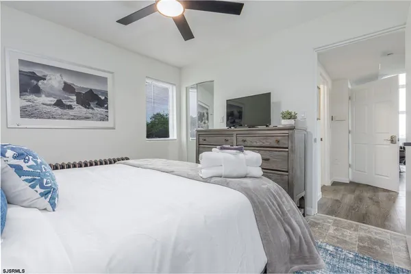 a bedroom with a large bed and a window