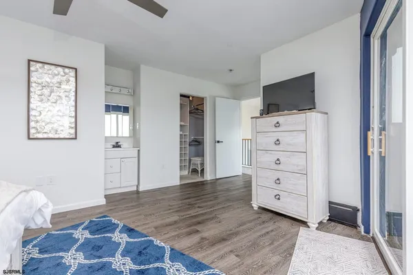 a bathroom with a granite countertop toilet sink and mirror