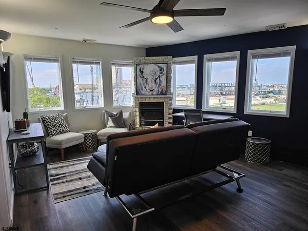 a living room with furniture fireplace and a large window