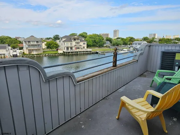 a view of a lake with a table and chairs