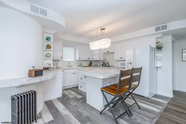 a room with chandelier furniture and a large window