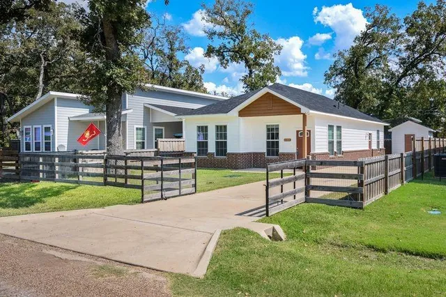 a view of a house with a yard and a garden