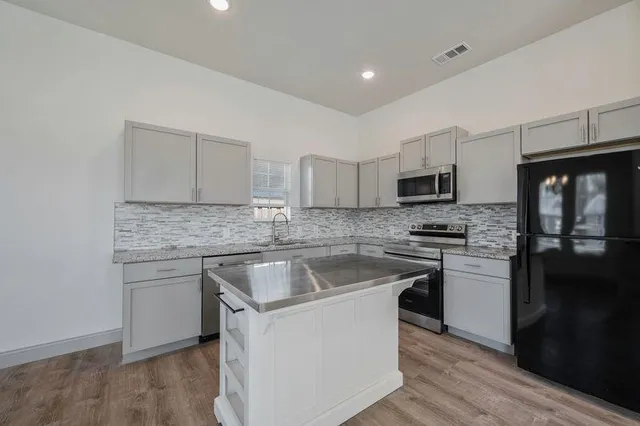 a kitchen with cabinets appliances and a counter space