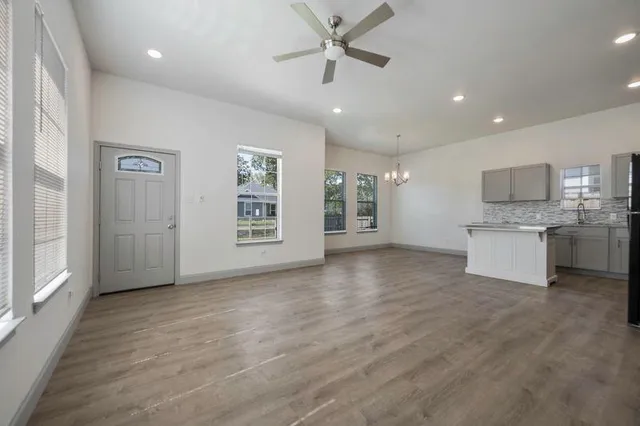 a view of a kitchen with a sink dishwasher cabinets and a kitchen