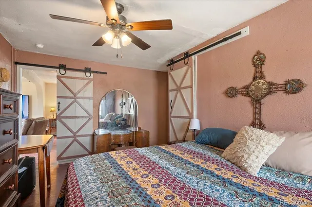 a bedroom with a bed and a chandelier