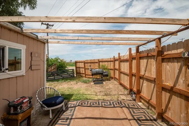 a patio with table and chairs