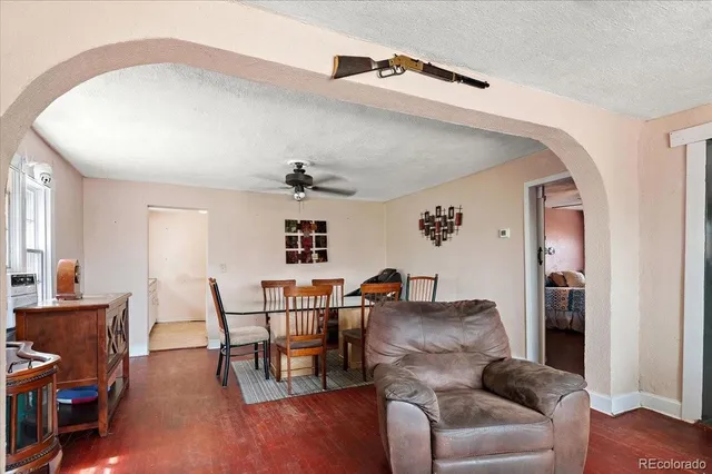 a living room with furniture and wooden floor