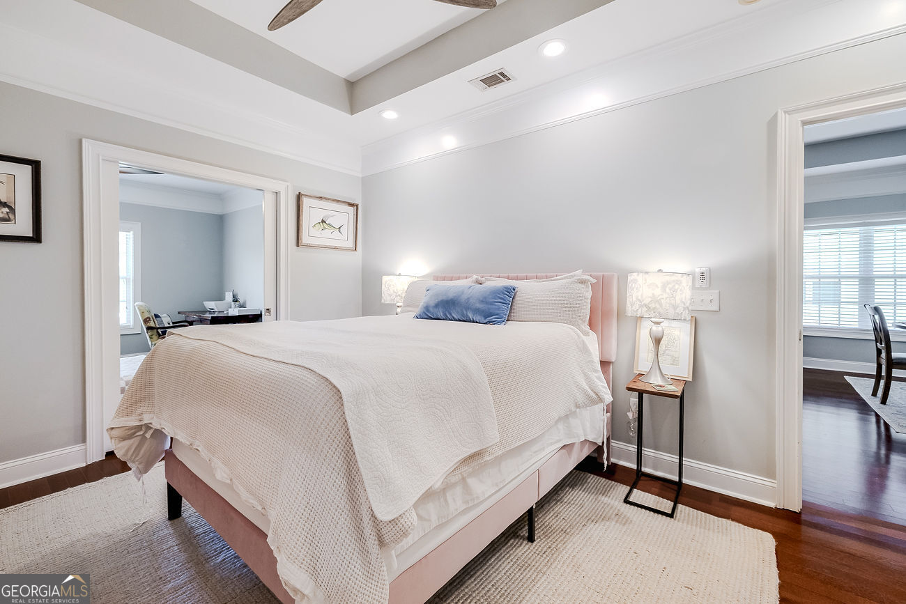 7272 Shellman Bluff Road Northeast, Unit 18 Townsend, GA 31331 - Photo 18 of 31 a bedroom with a bed and a night stand
