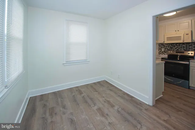 a view of wooden floor and a stove in a room