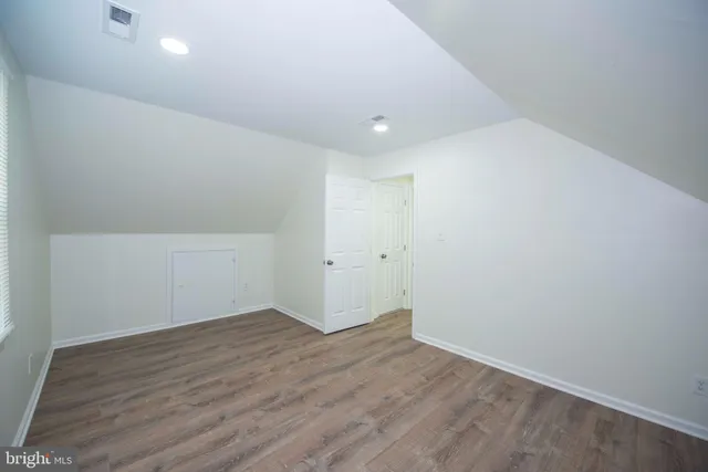 an empty room with wooden floor