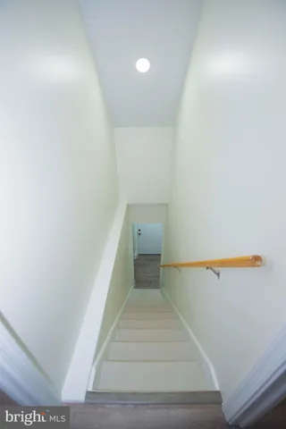 an empty room with wooden floor and entrance