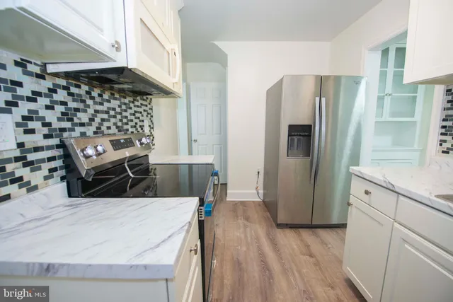 a kitchen with stainless steel appliances a refrigerator and a stove