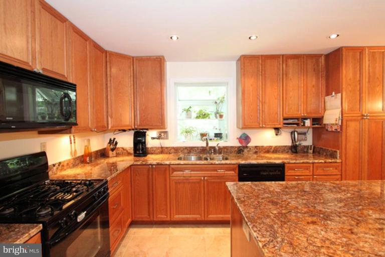 12504 Arbor View Terrace Silver Spring, MD 20902 - Photo 5 of 18 a kitchen with stainless steel appliances granite countertop a stove sink and cabinets