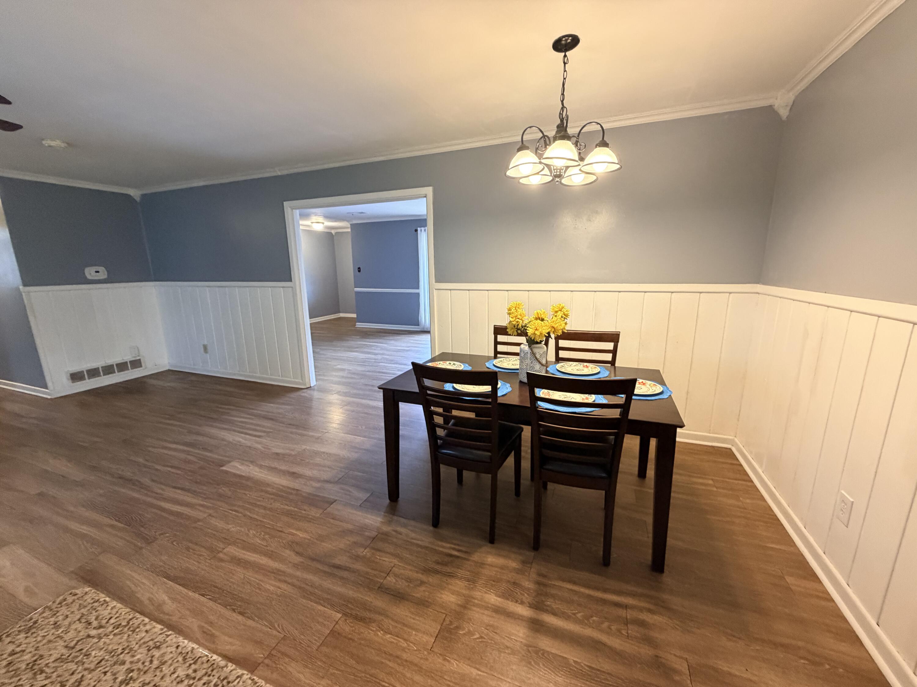 3814 27th Street Lubbock, TX 79410 - Photo 9 of 24 a view of a dining room with furniture and wooden floor