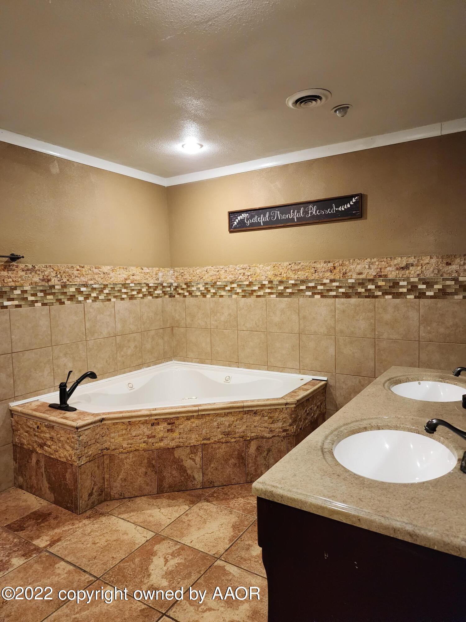 120 Pinon Street Borger, TX 79007 - Photo 11 of 19 a bathroom with a granite countertop sink and a mirror