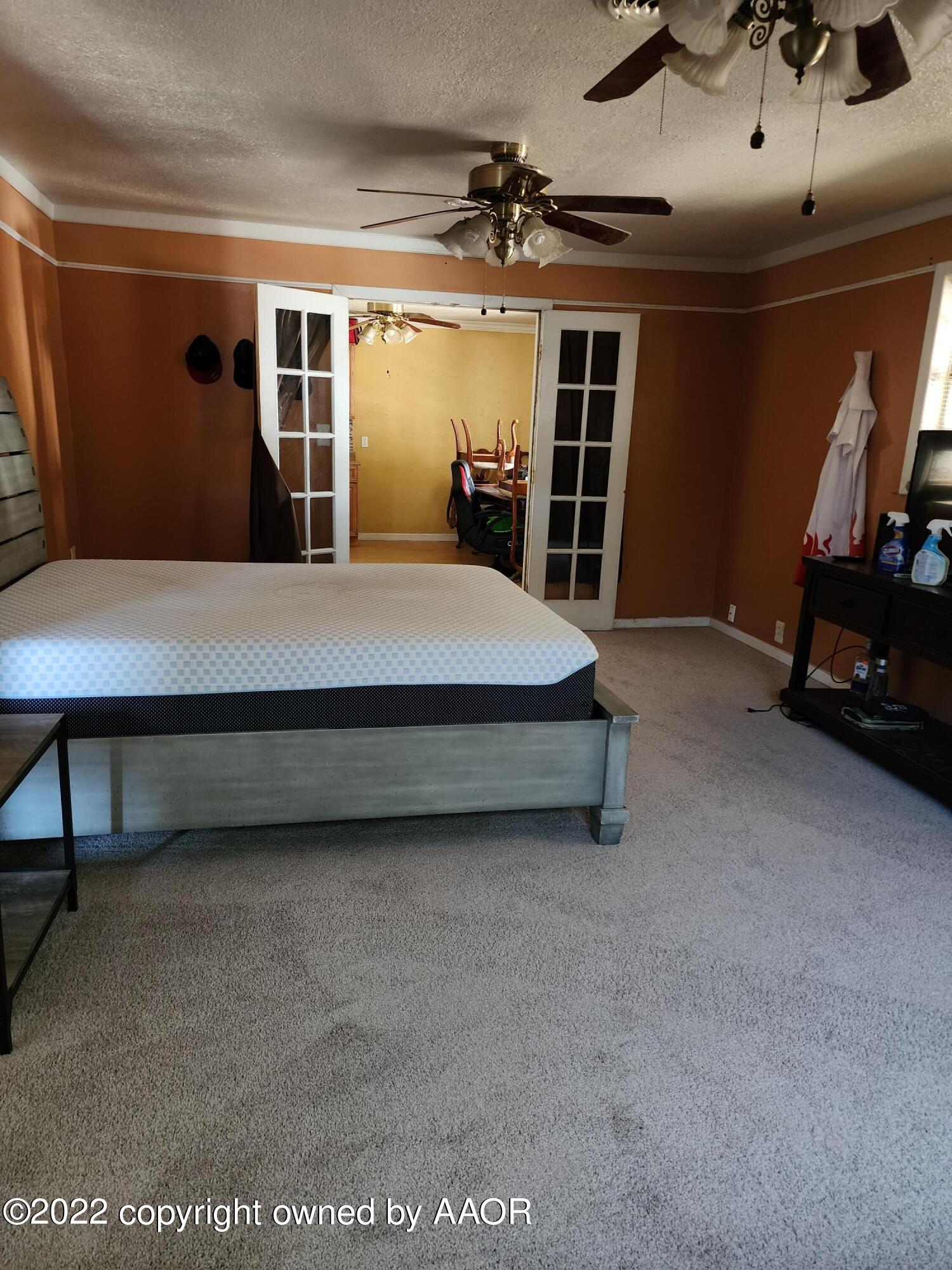 120 Pinon Street Borger, TX 79007 - Photo 12 of 19 a bed sitting in a room next to a window