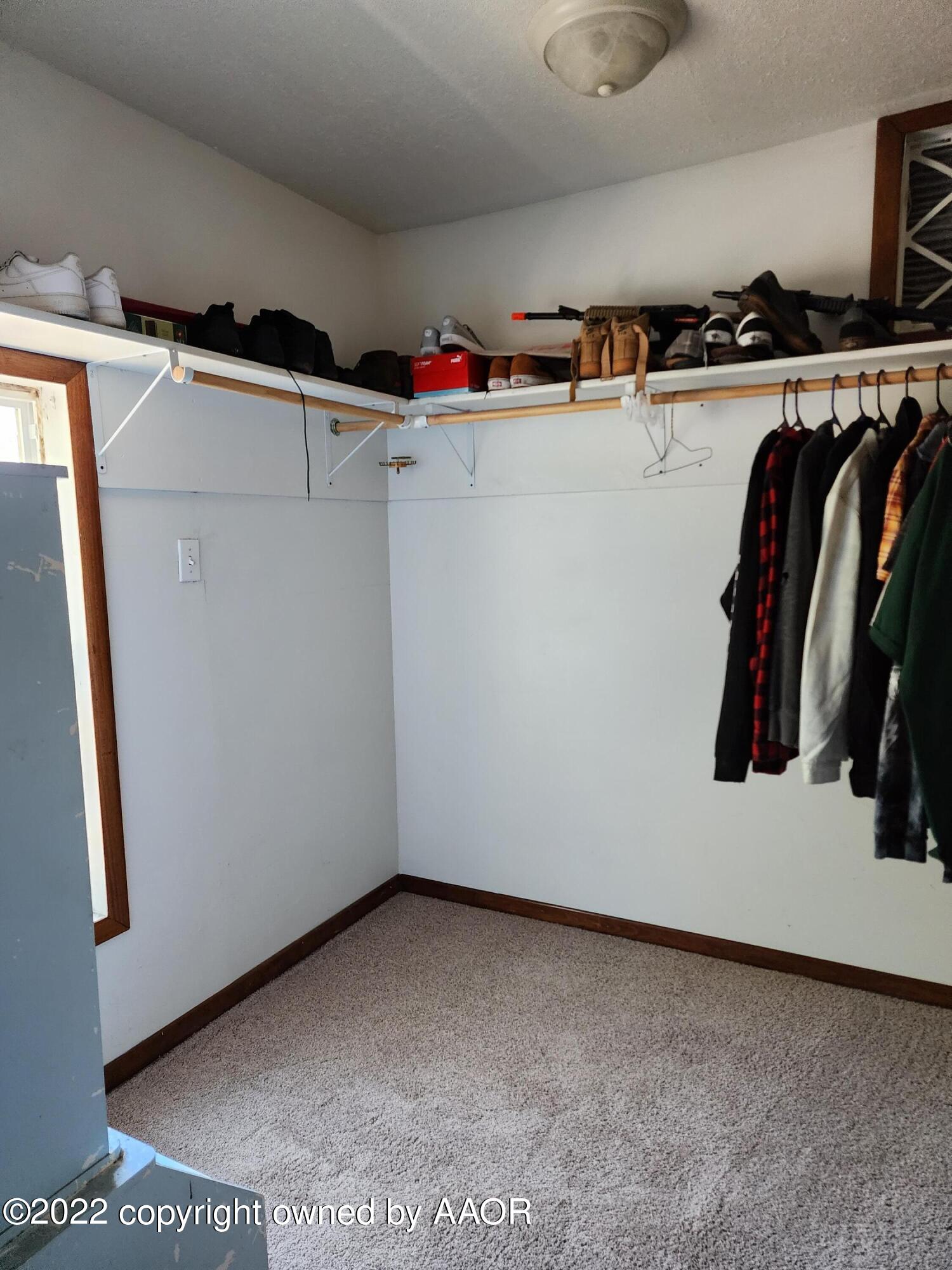 120 Pinon Street Borger, TX 79007 - Photo 13 of 19 a view of walk in closet with clothes and shoes