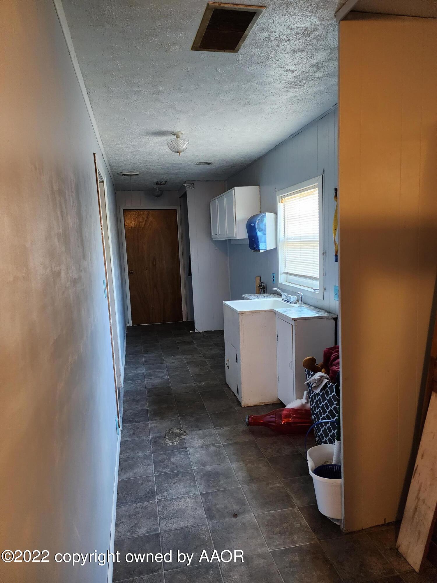 120 Pinon Street Borger, TX 79007 - Photo 18 of 19 a view of a hallway to room with a sink