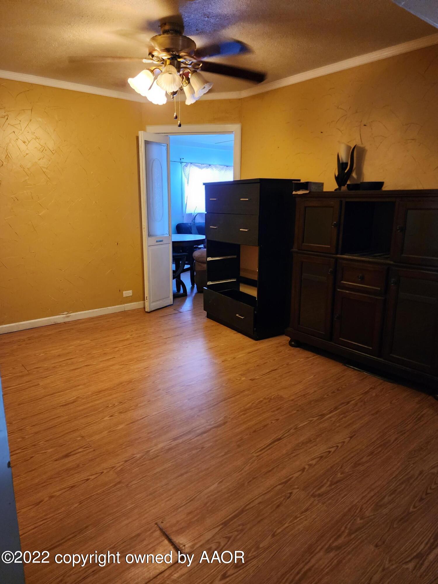 120 Pinon Street Borger, TX 79007 - Photo 7 of 19 a view of a room with a cabinet and a flat screen tv