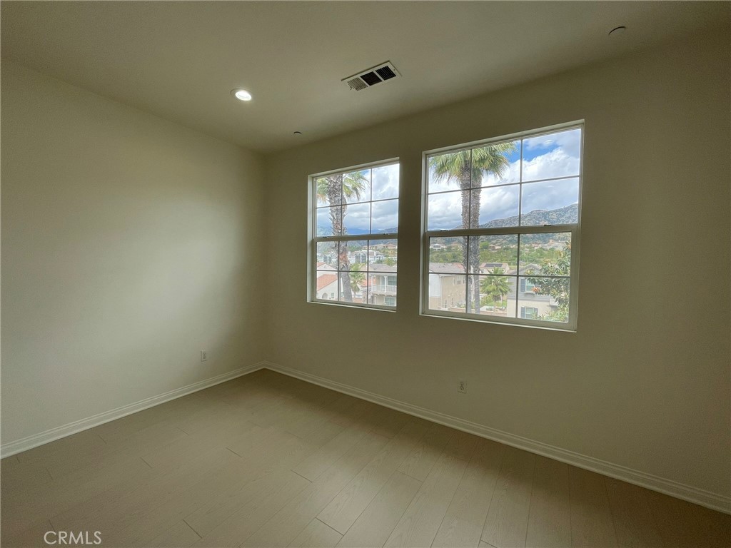 810 The Promenade, Unit C Azusa, CA 91702 - Photo 22 of 38 an empty room with a window
