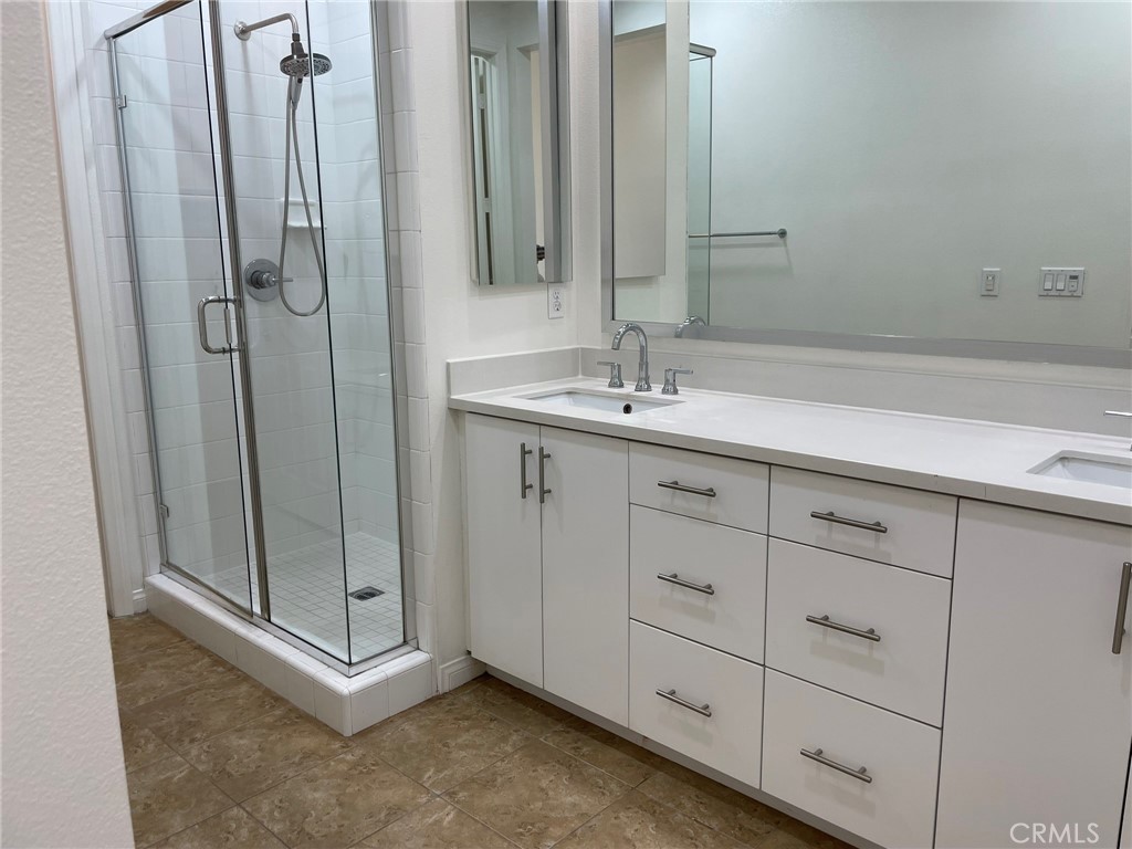 810 The Promenade, Unit C Azusa, CA 91702 - Photo 25 of 38 a bathroom with a double vanity sink and mirror