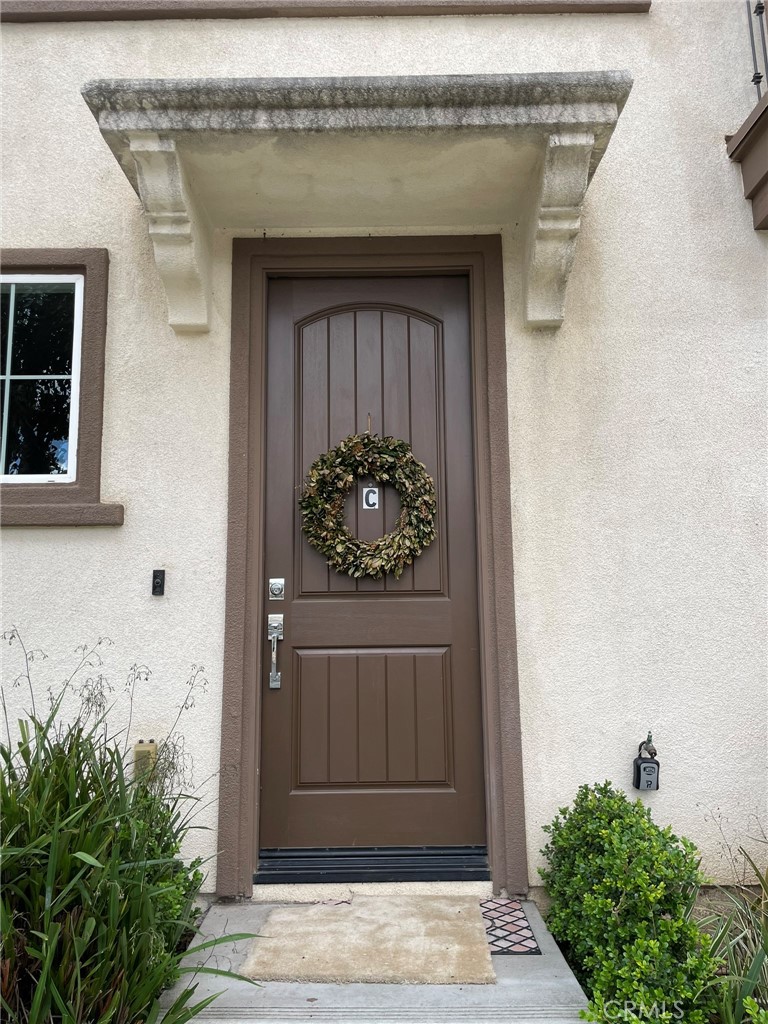 810 The Promenade, Unit C Azusa, CA 91702 - Photo 3 of 38 a front view of a house with potted plants