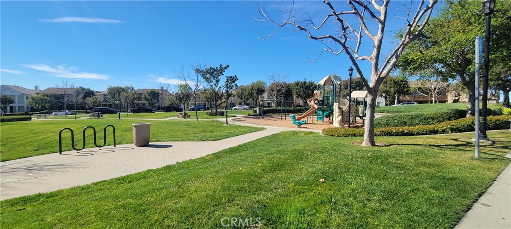 810 The Promenade, Unit C Azusa, CA 91702 - Photo 37 of 38 a view of a park with swings and a large tree