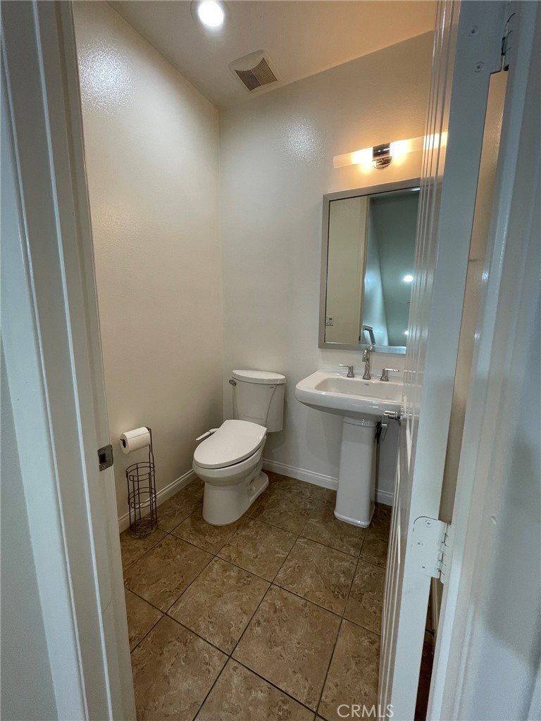 810 The Promenade, Unit C Azusa, CA 91702 - Photo 9 of 38 a bathroom with a sink toilet and a mirror