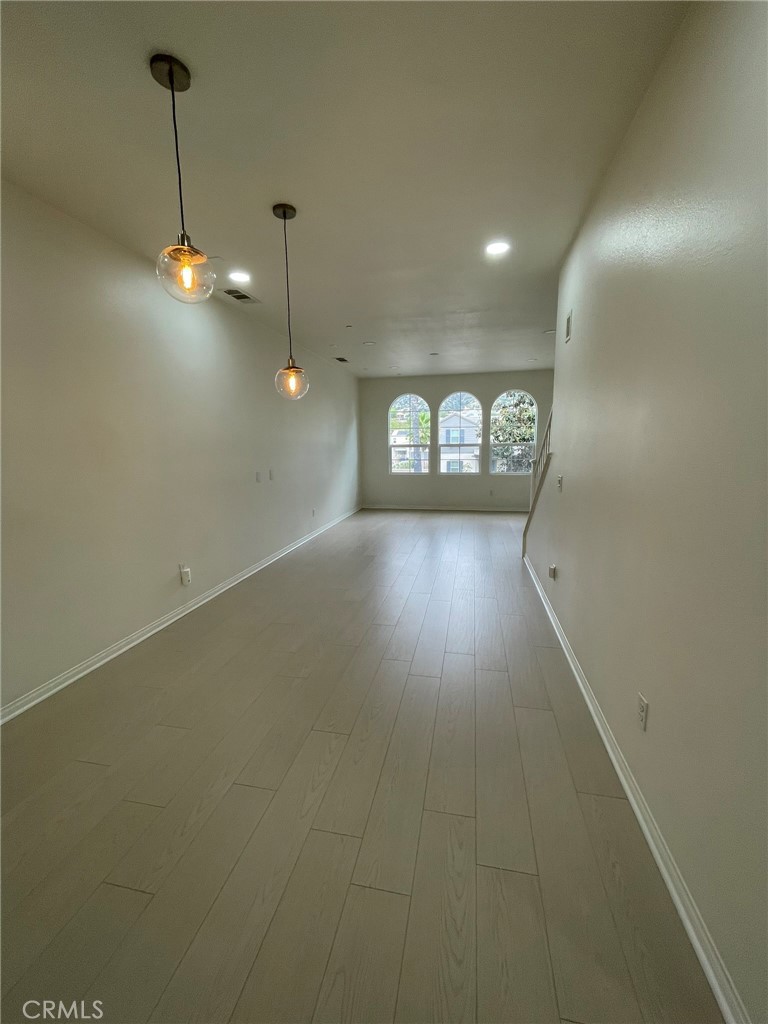 810 The Promenade, Unit C Azusa, CA 91702 - Photo 10 of 38 a view of a room with lots of wooden floor
