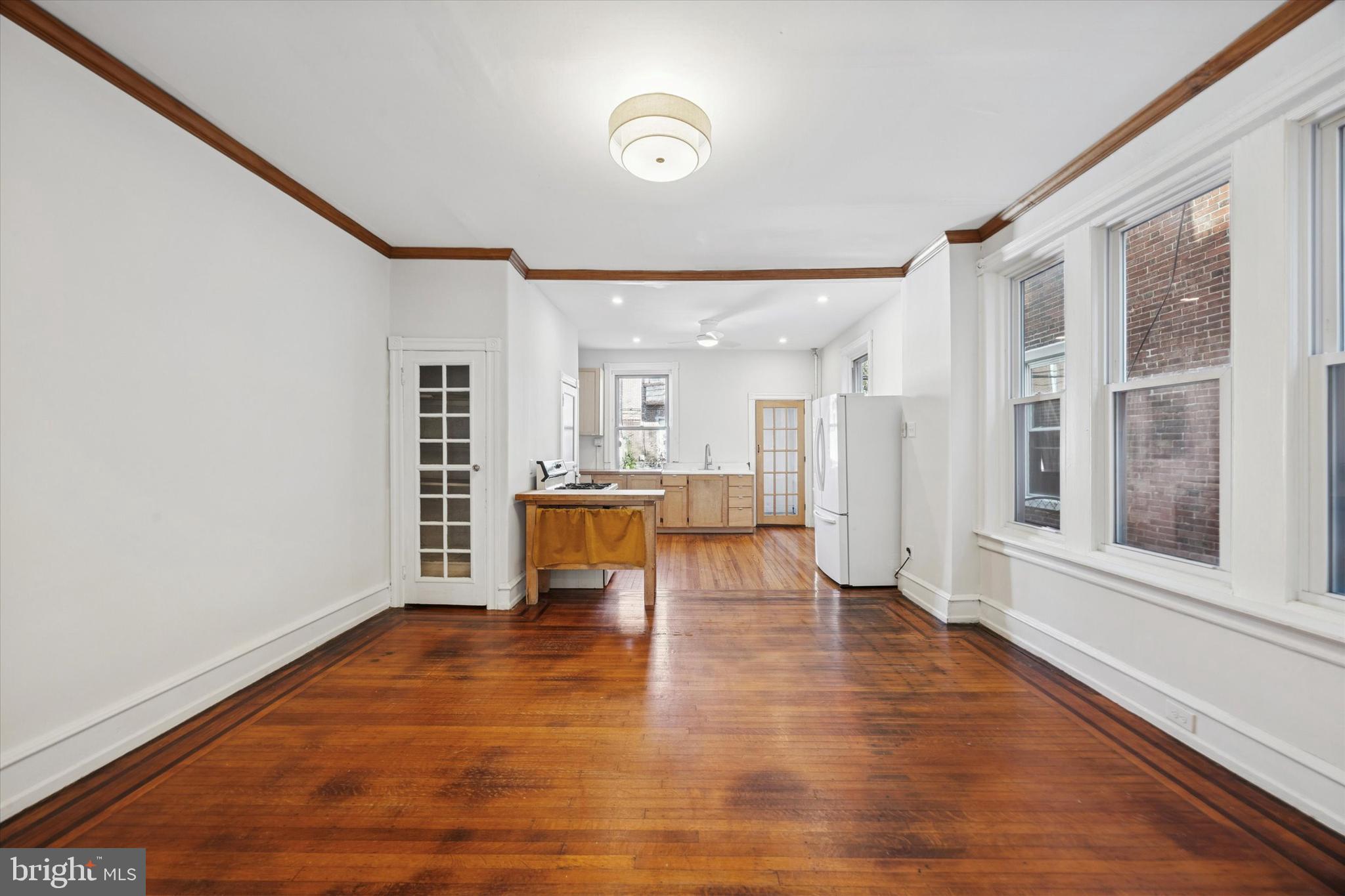 1227 South 53rd Street Philadelphia, PA 19143 - Photo 11 of 31 a view of an empty room with wooden floor and a window