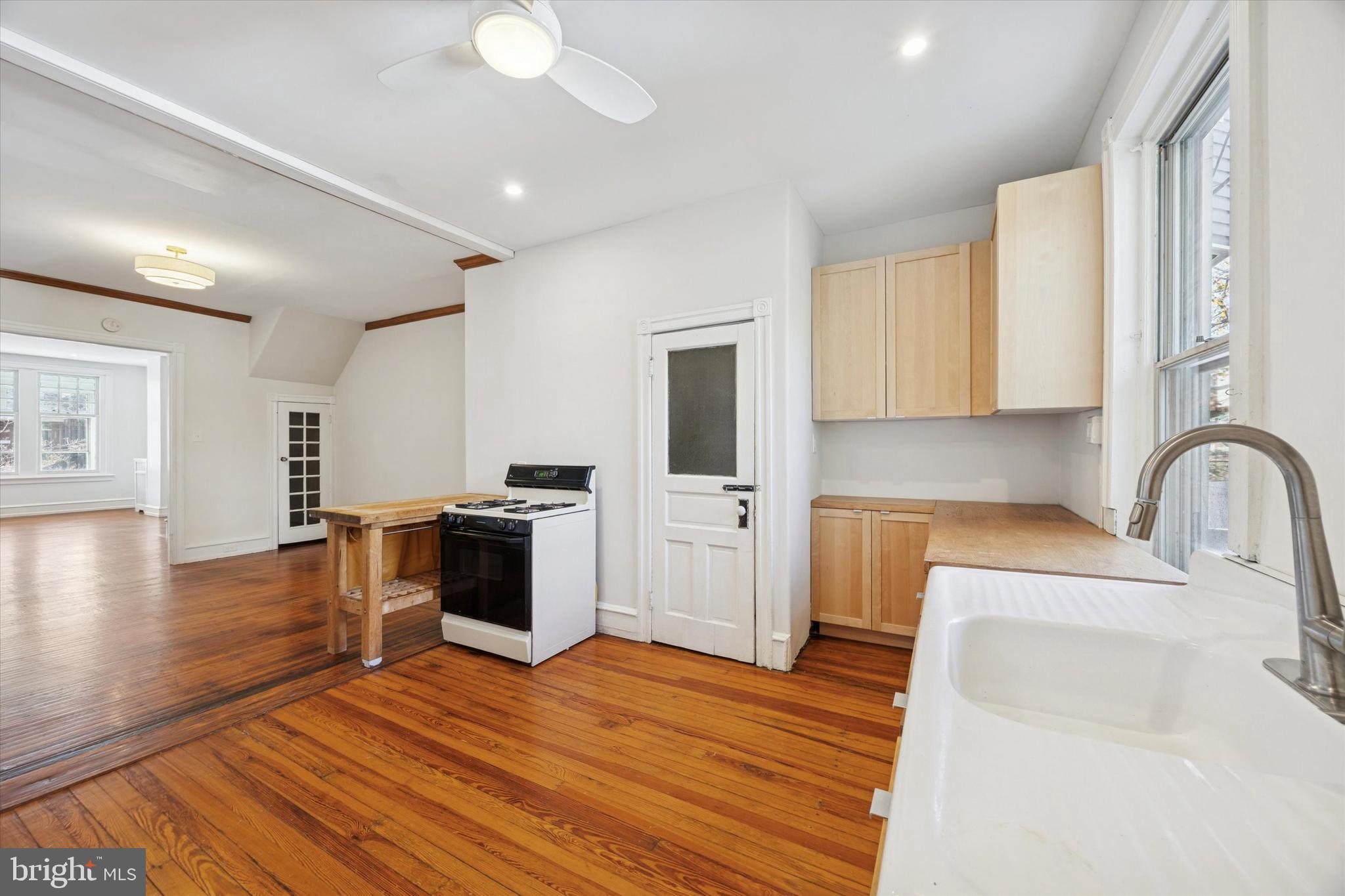 1227 South 53rd Street Philadelphia, PA 19143 - Photo 14 of 31 a kitchen with stainless steel appliances granite countertop a sink cabinets and wooden floor