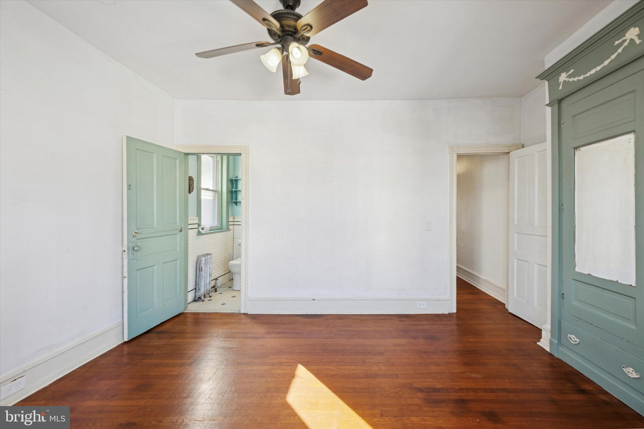 1227 South 53rd Street Philadelphia, PA 19143 - Photo 24 of 31 an empty room with wooden floor cabinet and windows