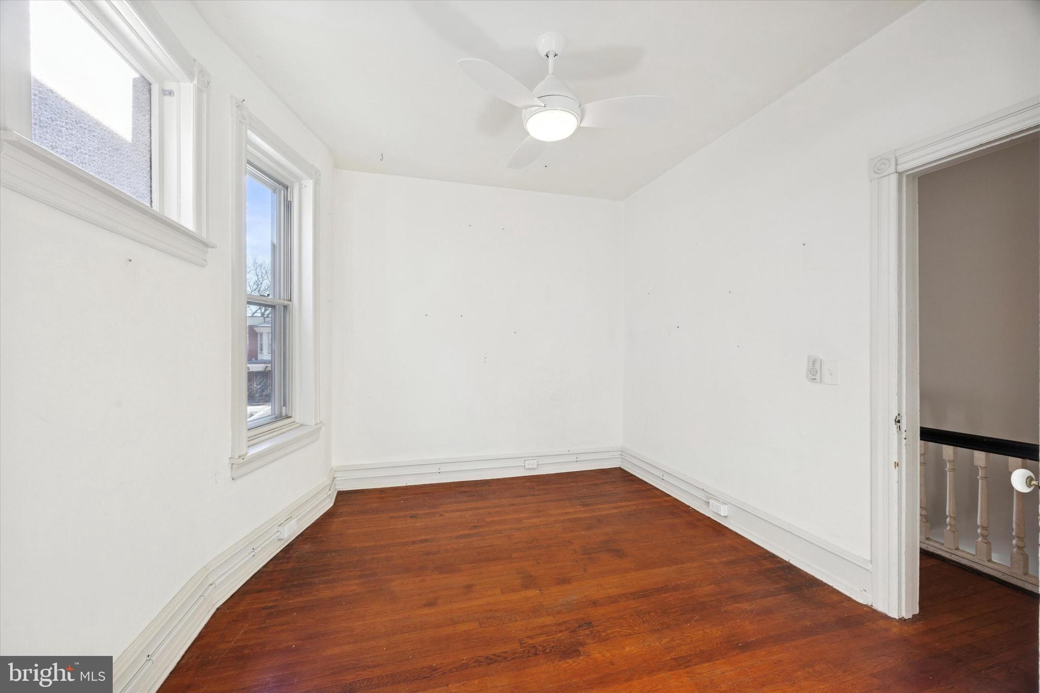 1227 South 53rd Street Philadelphia, PA 19143 - Photo 29 of 31 a view of an empty room with wooden floor and a window