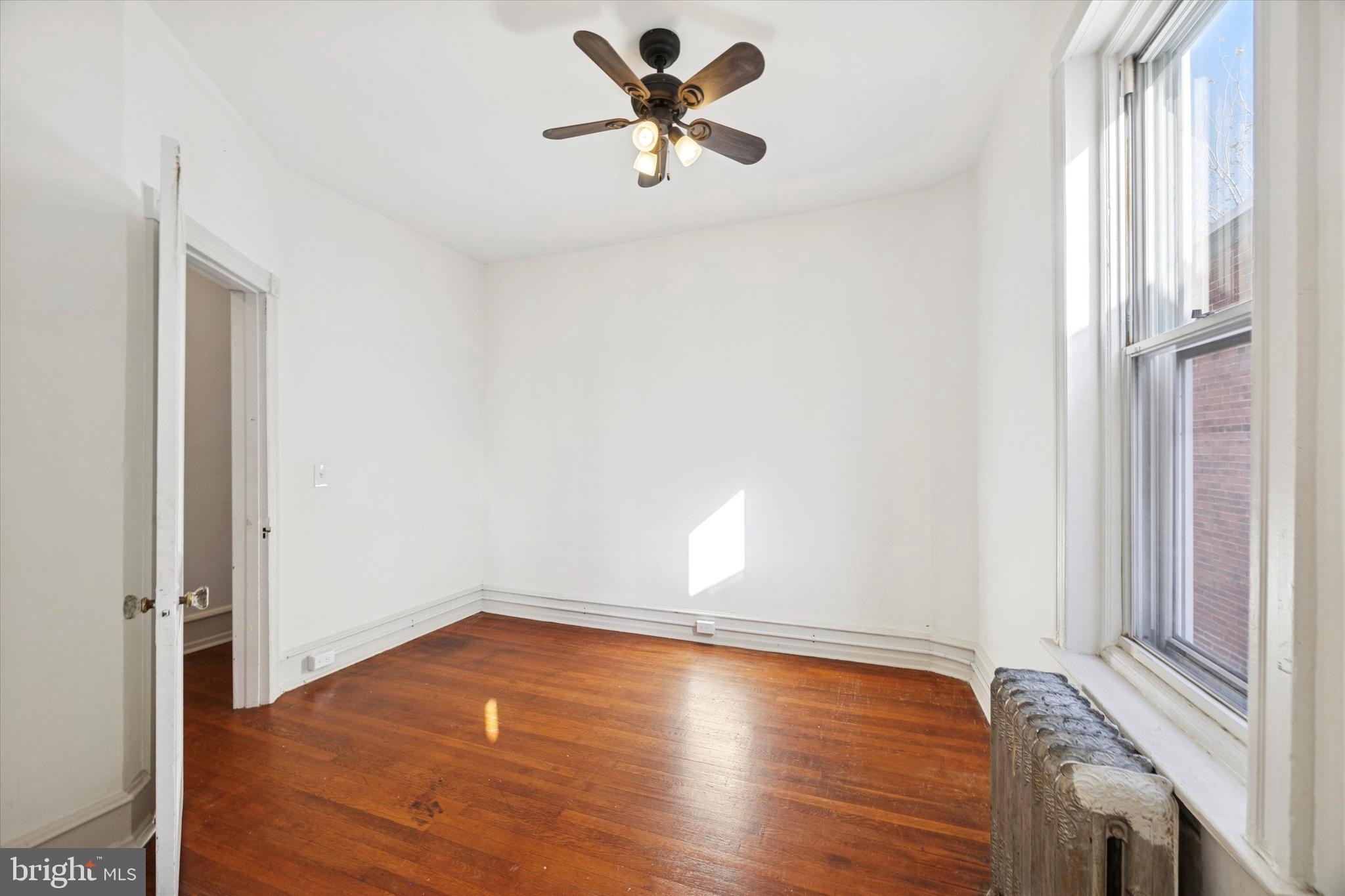 1227 South 53rd Street Philadelphia, PA 19143 - Photo 31 of 31 a view of room with hardwood floor and a ceiling fan