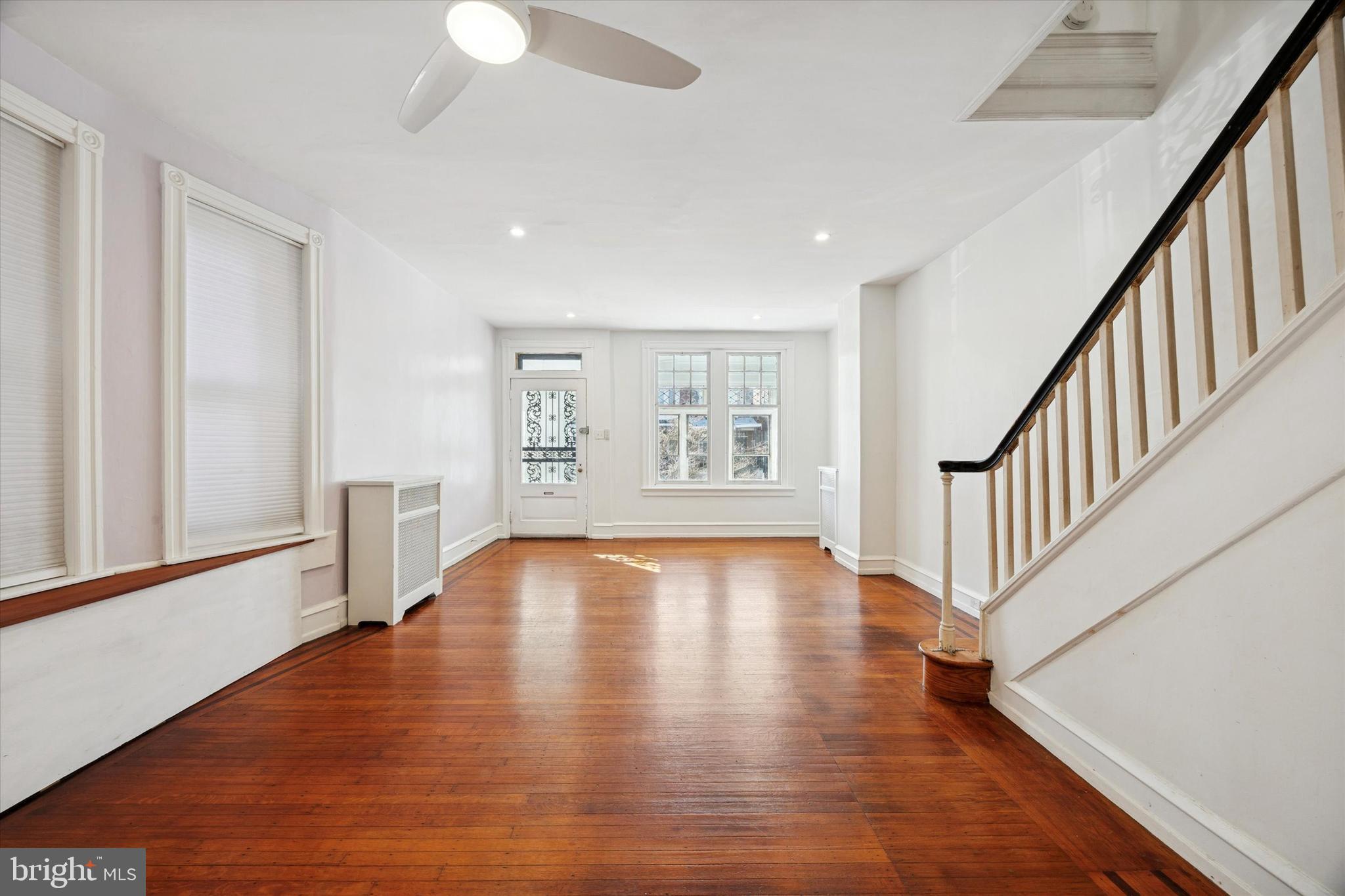 1227 South 53rd Street Philadelphia, PA 19143 - Photo 4 of 31 a view of an empty room with wooden floor and a window