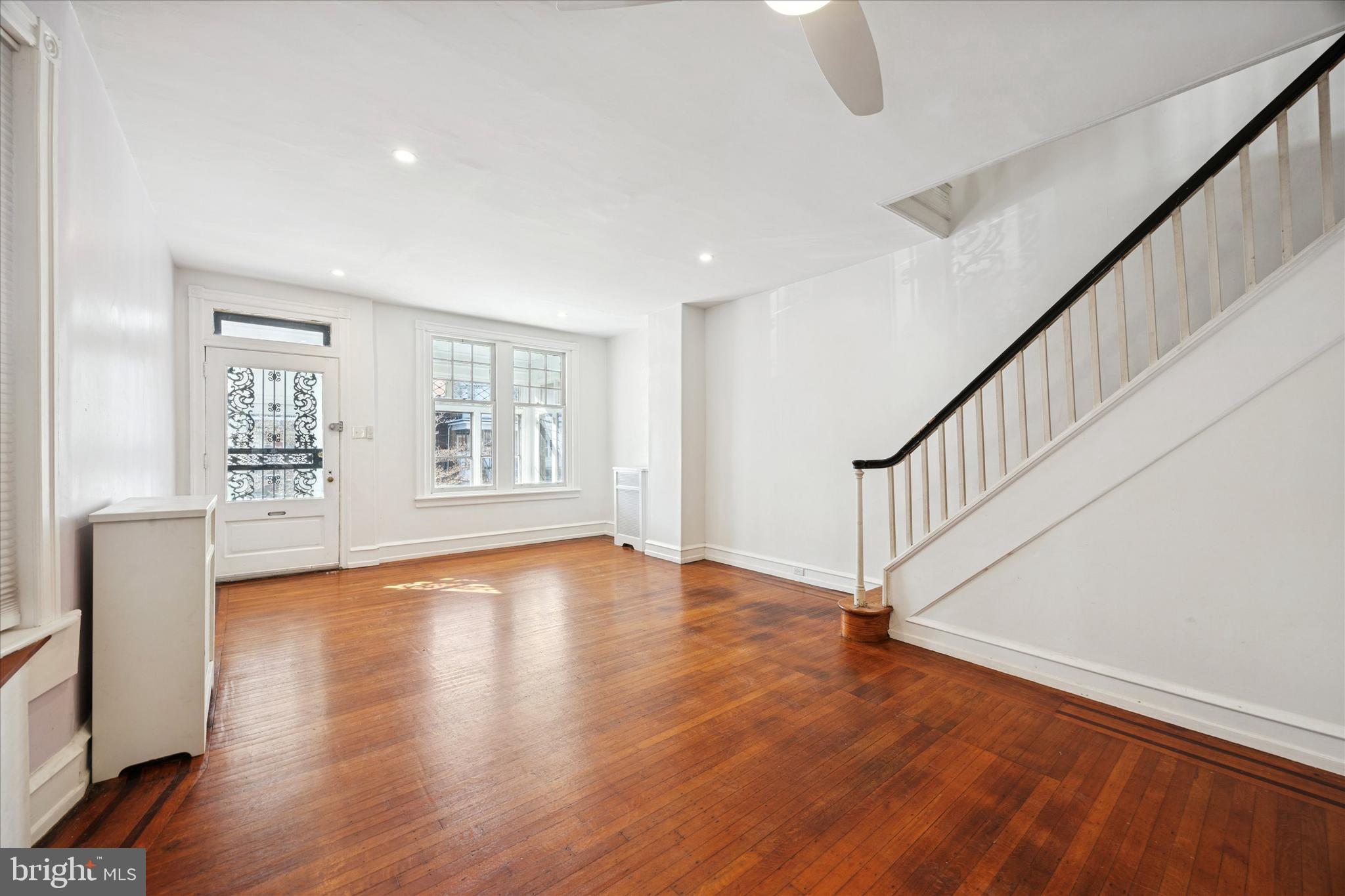 1227 South 53rd Street Philadelphia, PA 19143 - Photo 5 of 31 a view of an empty room with wooden floor and a window