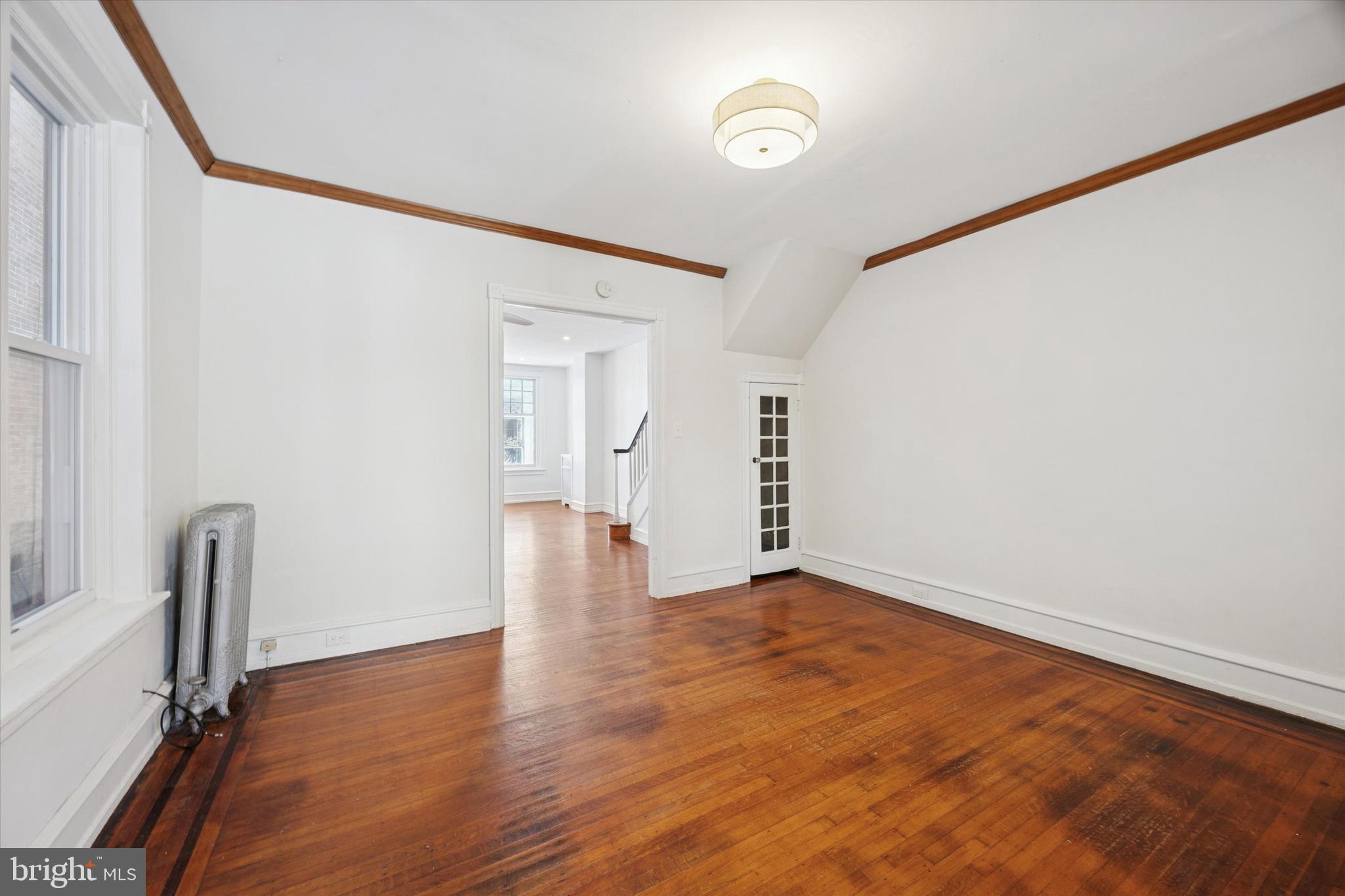 1227 South 53rd Street Philadelphia, PA 19143 - Photo 10 of 31 a view of an empty room with wooden floor and a window