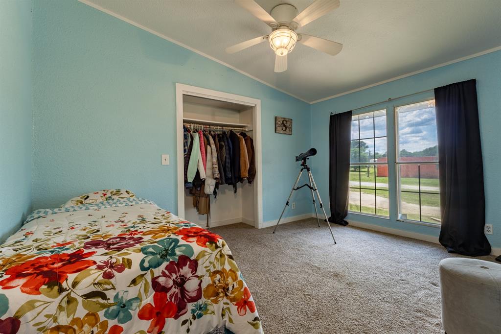 75 Southern Road Mineral Wells, TX 76067 - Photo 22 of 31 a bedroom with a bed and a chandelier
