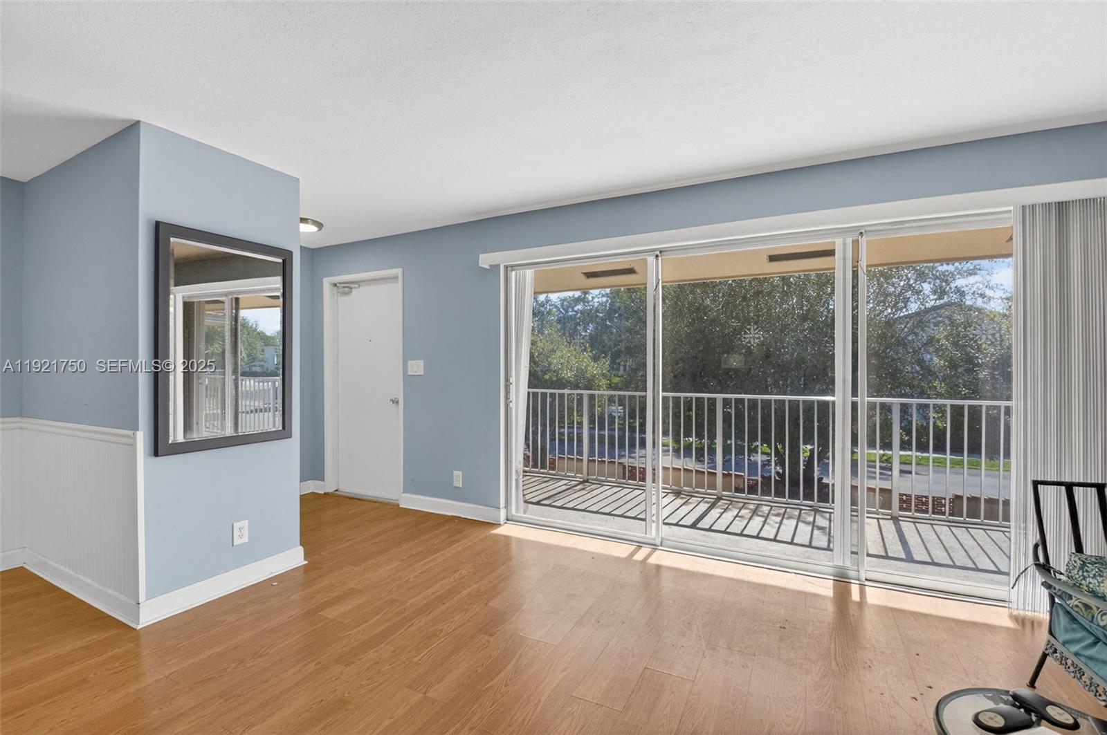 371 Southwest 8th Street, Unit 2C Boca Raton, FL 33432 - Photo 1 of 13 a view of a room with wooden floor and a window