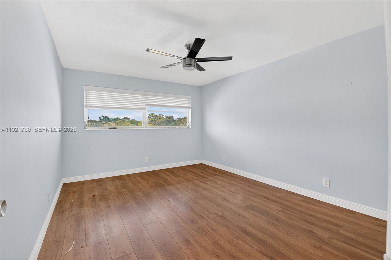 371 Southwest 8th Street, Unit 2C Boca Raton, FL 33432 - Photo 11 of 13 wooden floor in an empty room with a window